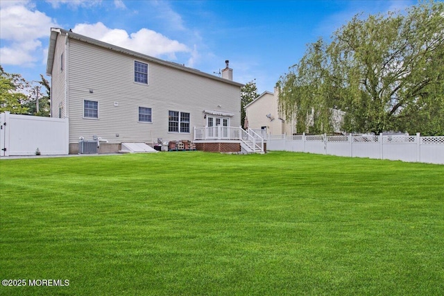 519 Gilford Ave, Toms River, NJ 08753 - back of property with a wooden deck, a chimney, and a fenced backyard