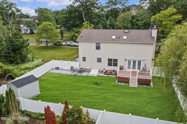 519 Gilford Ave, Toms River, NJ 08753 - back of property featuring a deck, a fenced backyard, a chimney, and a patio area