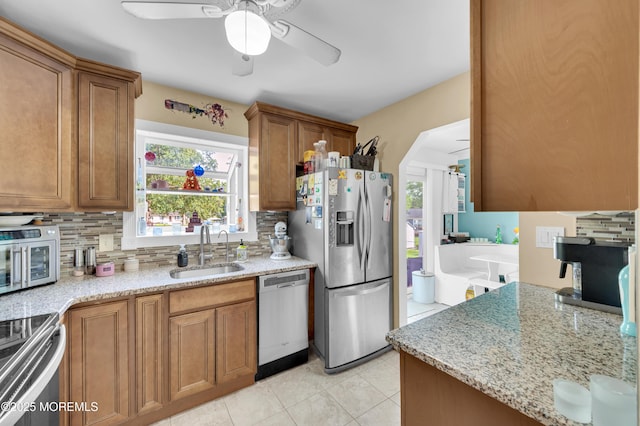 5 Robert Ave, Howell, NJ 07731 - kitchen with appliances with stainless steel finishes, a ceiling fan, brown cabinetry, decorative backsplash, and healthy amount of natural light