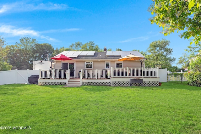 5 Robert Ave, Howell, NJ 07731 - rear view of property featuring a fenced backyard, solar panels, and a deck