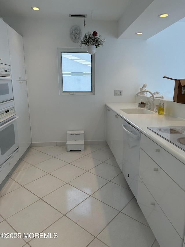 5205 Ocean Dr S, Brigantine City, NJ 08203 - kitchen featuring white appliances, white cabinets, light countertops, light tile patterned floors, and recessed lighting