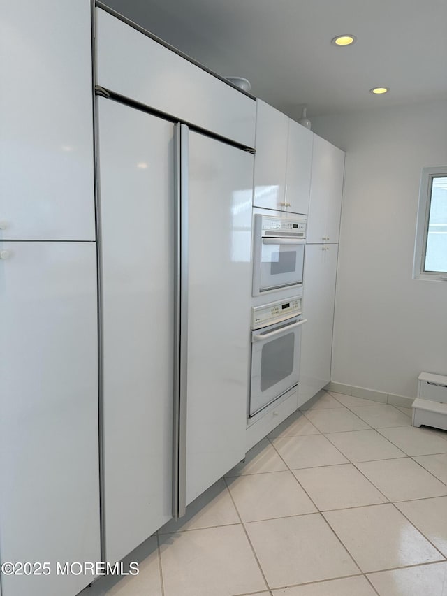 5205 Ocean Dr S, Brigantine City, NJ 08203 - kitchen with paneled built in refrigerator, white cabinetry, recessed lighting, double oven, and light tile patterned floors