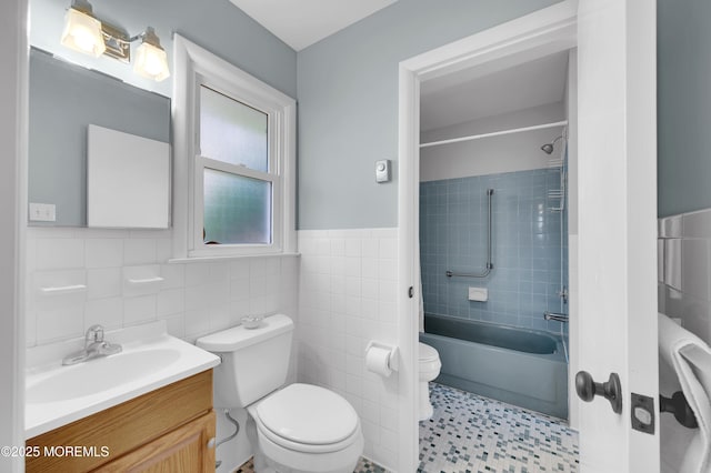 7 Robinson Rd, Brick, NJ 08724 - bathroom featuring tile walls, vanity,  shower combination, and a wainscoted wall