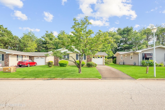 7 Robinson Rd, Brick, NJ 08724 - view of front of home with asphalt driveway, a front lawn, and a garage