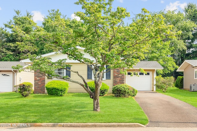 7 Robinson Rd, Brick, NJ 08724 - obstructed view of property with asphalt driveway, a front lawn, and a garage