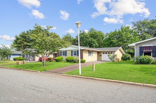 7 Robinson Rd, Brick, NJ 08724 - view of front of property with driveway, an attached garage, and a front lawn