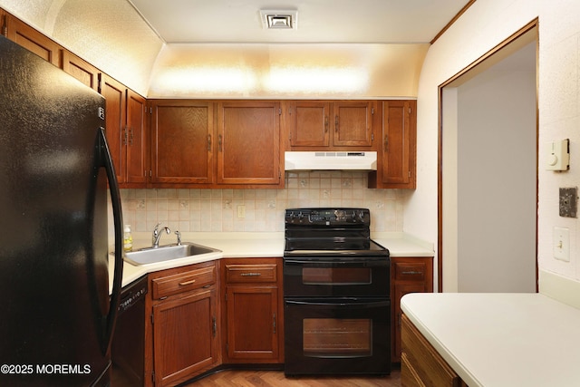 33 Claremont Ct, Red Bank, NJ 07701 - kitchen featuring black appliances, under cabinet range hood, backsplash, light countertops, and brown cabinetry