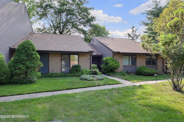 33 Claremont Ct, Red Bank, NJ 07701 - view of front facade featuring brick siding, a front yard, and a shingled roof