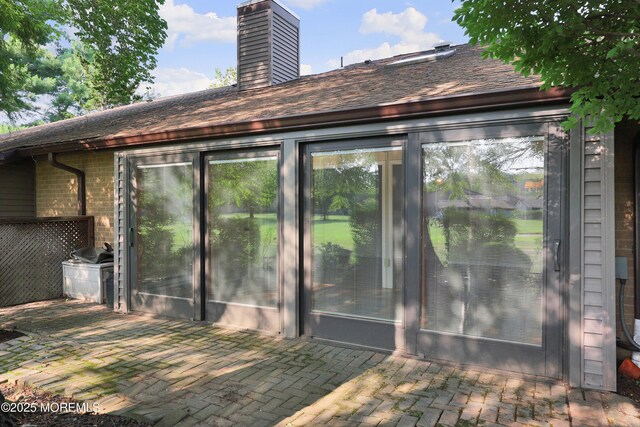 33 Claremont Ct, Red Bank, NJ 07701 - back of house featuring a chimney, brick siding, and roof with shingles
