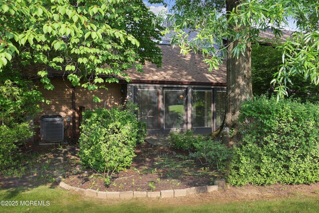 33 Claremont Ct, Red Bank, NJ 07701 - view of side of property featuring a shingled roof and a sunroom