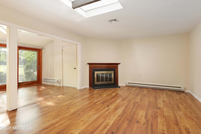33 Claremont Ct, Red Bank, NJ 07701 - unfurnished living room featuring a baseboard heating unit, light wood-style flooring, a glass covered fireplace, and a skylight