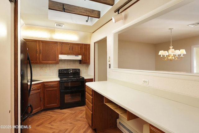 33 Claremont Ct, Red Bank, NJ 07701 - kitchen with black / electric stove, under cabinet range hood, light countertops, decorative backsplash, and brown cabinetry