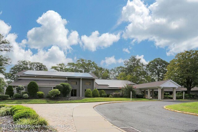 33 Claremont Ct, Red Bank, NJ 07701 - view of front of property featuring curved driveway, a front lawn, and stucco siding