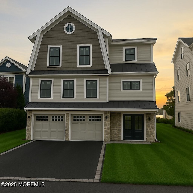 1623 Northstream Pkwy, Point Pleasant, NJ 08742 - view of front of property featuring stone siding, a standing seam roof, a lawn, and driveway