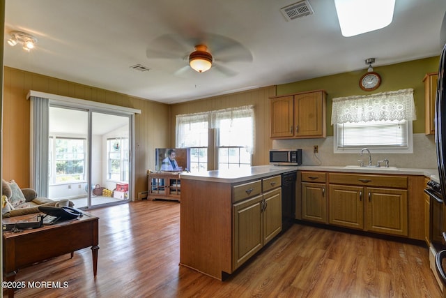 861 Jamaica Blvd, Toms River, NJ 08757 - kitchen with black dishwasher, a ceiling fan, stainless steel microwave, a peninsula, and plenty of natural light