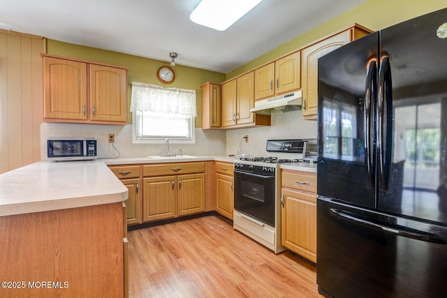 861 Jamaica Blvd, Toms River, NJ 08757 - kitchen with freestanding refrigerator, white gas range, under cabinet range hood, stainless steel microwave, and light wood-style flooring