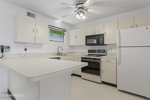 255 Shore Dr Unit 8, Highlands, NJ 07732 - kitchen featuring white appliances, a peninsula, light countertops, a ceiling fan, and a textured ceiling