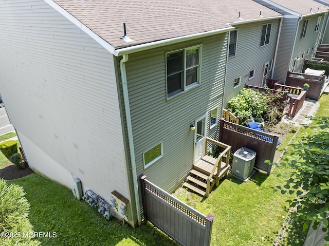 255 Shore Dr Unit 8, Highlands, NJ 07732 - rear view of property with a deck, roof with shingles, and a yard