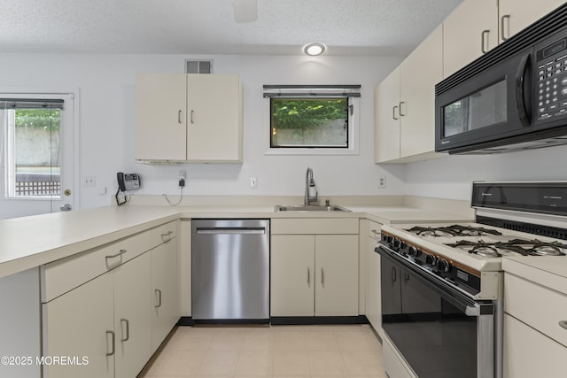 255 Shore Dr Unit 8, Highlands, NJ 07732 - kitchen featuring dishwasher, white gas stove, black microwave, a textured ceiling, and light countertops