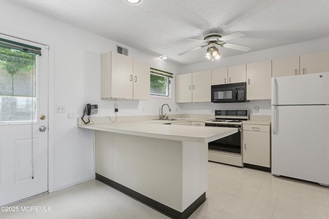 255 Shore Dr Unit 8, Highlands, NJ 07732 - kitchen featuring white appliances, a peninsula, light countertops, cream cabinetry, and ceiling fan