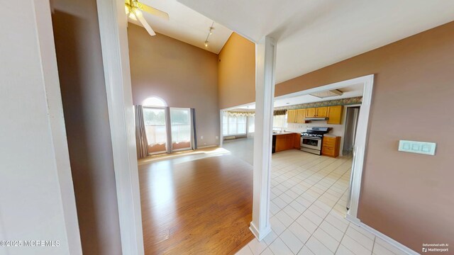 5 Samantha Dr, Monroe, NJ 08831 - unfurnished living room with high vaulted ceiling, a ceiling fan, and light tile patterned floors