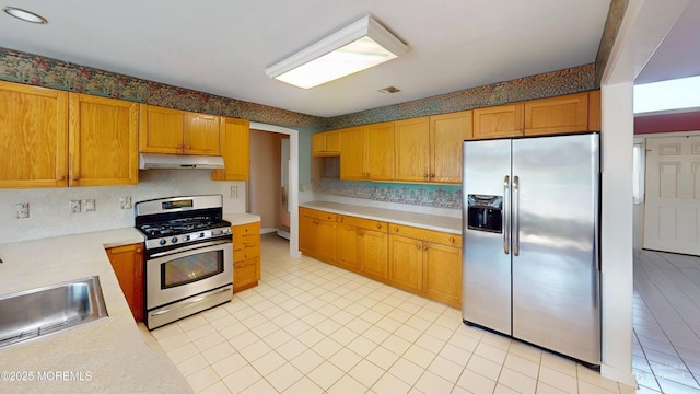 5 Samantha Dr, Monroe, NJ 08831 - kitchen featuring appliances with stainless steel finishes, under cabinet range hood, light countertops, light tile patterned flooring, and tasteful backsplash