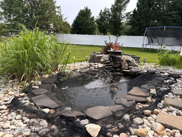 5 Samantha Dr, Monroe, NJ 08831 - fenced backyard with a trampoline and a small pond