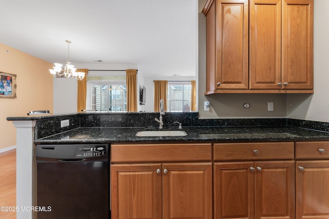 632 Sophee Ln, Lakewood, NJ 08701 - kitchen featuring black dishwasher, dark stone countertops, brown cabinetry, light wood-style flooring, and a chandelier