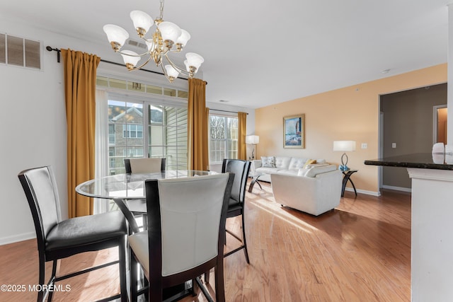 632 Sophee Ln, Lakewood, NJ 08701 - dining space with a chandelier and light wood finished floors