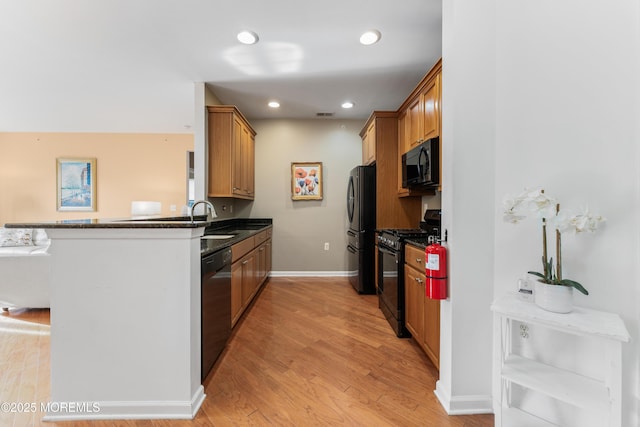 632 Sophee Ln, Lakewood, NJ 08701 - kitchen with black appliances, dark countertops, light wood-style flooring, brown cabinets, and recessed lighting