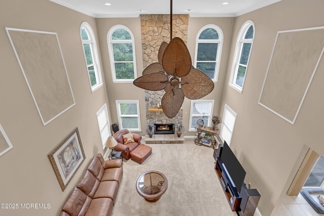 329 Valley View Cir, Freehold, NJ 07728 - living room with healthy amount of natural light, a stone fireplace, ornamental molding, a high ceiling, and recessed lighting