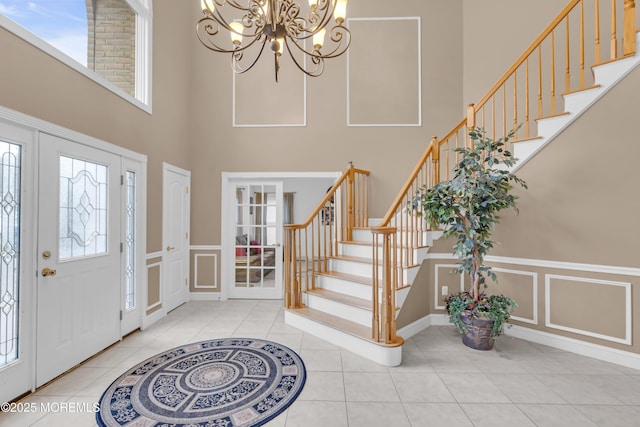 329 Valley View Cir, Freehold, NJ 07728 - foyer featuring a high ceiling, a decorative wall, a chandelier, stairway, and light tile patterned floors