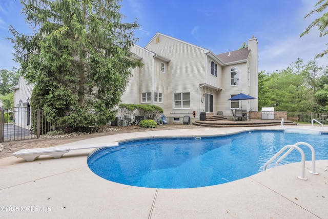 329 Valley View Cir, Freehold, NJ 07728 - view of swimming pool featuring a patio area, a diving board, and a gate