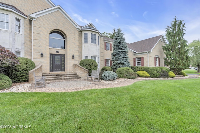329 Valley View Cir, Freehold, NJ 07728 - view of front facade featuring brick siding, a front yard, and entry steps