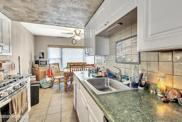 74 Fieldcrest Way, Hazlet, NJ 07730 - kitchen featuring gas stove, white cabinetry, ceiling fan, tasteful backsplash, and dark countertops