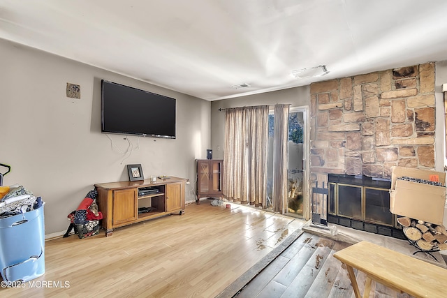 74 Fieldcrest Way, Hazlet, NJ 07730 - living area featuring light wood-style flooring, a stone fireplace, and heating unit