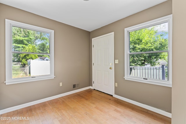 76 9th St, Belford, NJ 07718 - empty room featuring healthy amount of natural light and light wood-style flooring