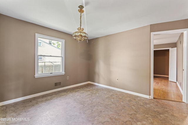 76 9th St, Belford, NJ 07718 - spare room with a chandelier and baseboards