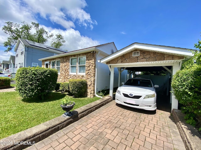 451 Brookside Ave, Laurence Harbor, NJ 08879 - view of front of house featuring stone siding, decorative driveway, and a front lawn