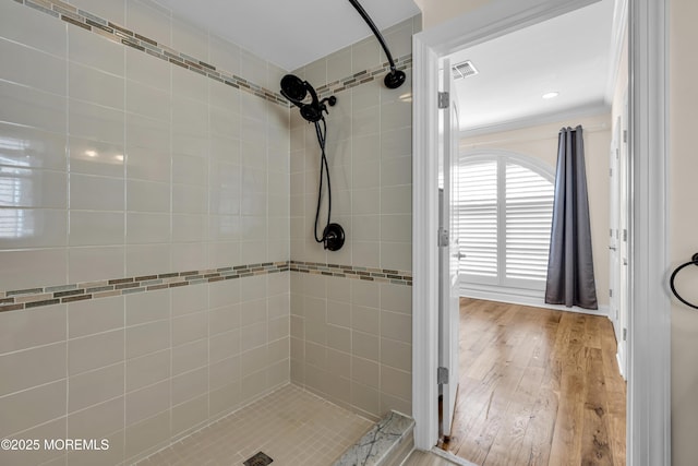 14 Seadrift Ave, Highlands, NJ 07732 - bathroom featuring a tile shower, crown molding, and wood finished floors
