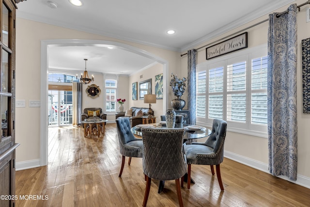 14 Seadrift Ave, Highlands, NJ 07732 - dining space with ornamental molding, arched walkways, hardwood / wood-style flooring, a chandelier, and plenty of natural light