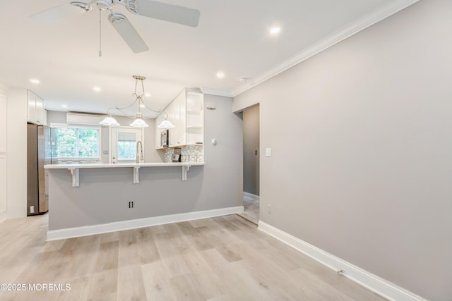 6 S Heron St Unit A, Manchester, NJ 08759 - kitchen with open shelves, stainless steel appliances, white cabinetry, ceiling fan, and a peninsula