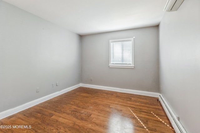 6 S Heron St Unit A, Manchester, NJ 08759 - spare room with a baseboard radiator, wood finished floors, and a wall unit AC