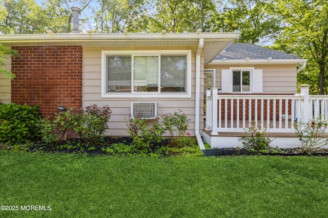 6 S Heron St Unit A, Manchester, NJ 08759 - view of front facade featuring a front lawn, a wooden deck, and a shingled roof