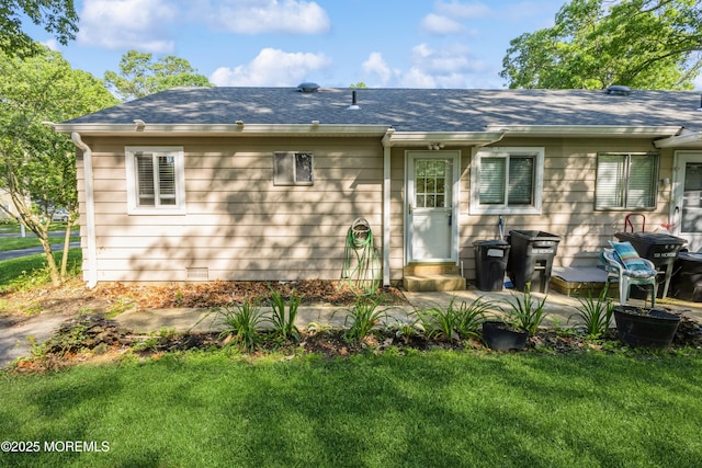 6 S Heron St Unit A, Manchester, NJ 08759 - rear view of house featuring a lawn and a shingled roof
