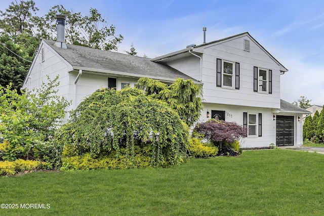 1217 Madison Ave, Toms River, NJ 08757 - tri-level home featuring a front yard, an attached garage, a shingled roof, and driveway