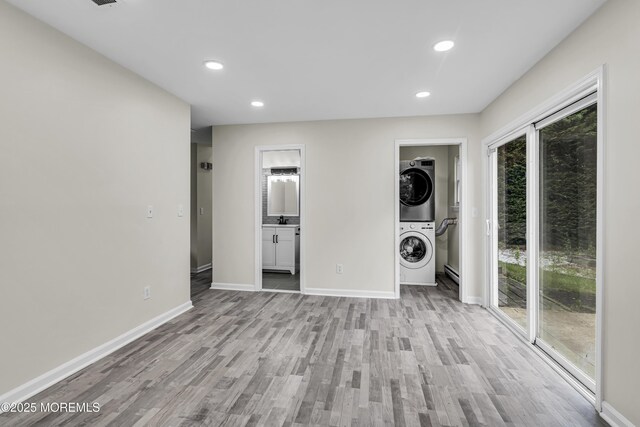 1217 Madison Ave, Toms River, NJ 08757 - laundry room featuring estacked washer and dryer, light wood-style floors, and recessed lighting