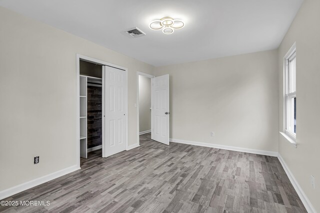1217 Madison Ave, Toms River, NJ 08757 - unfurnished bedroom with wood finished floors and a closet