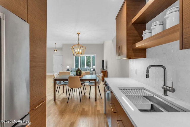 8 Eunice Ter, West Long Branch, NJ 07764 - kitchen featuring open shelves, stainless steel appliances, decorative backsplash, and brown cabinets