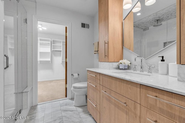 8 Eunice Ter, West Long Branch, NJ 07764 - bathroom with a stall shower, a walk in closet, vanity, marble finish floors, and recessed lighting